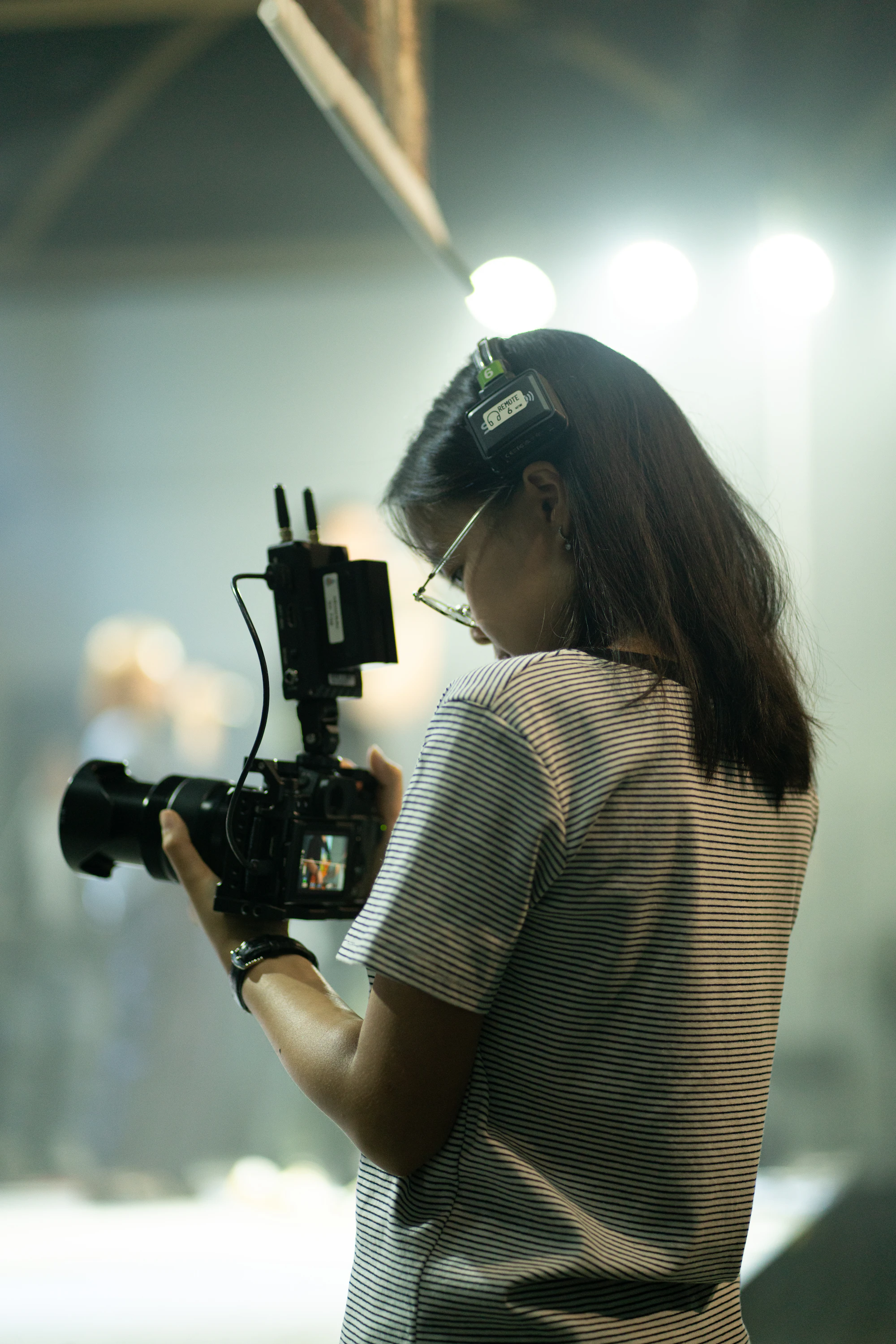 A camera operator filming in the field