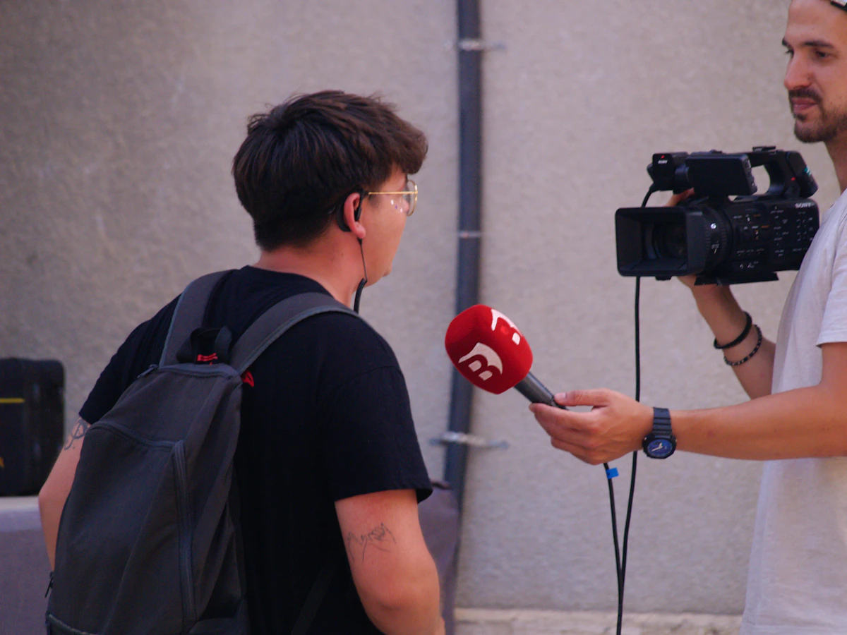 A reporter interviewing someone on camera